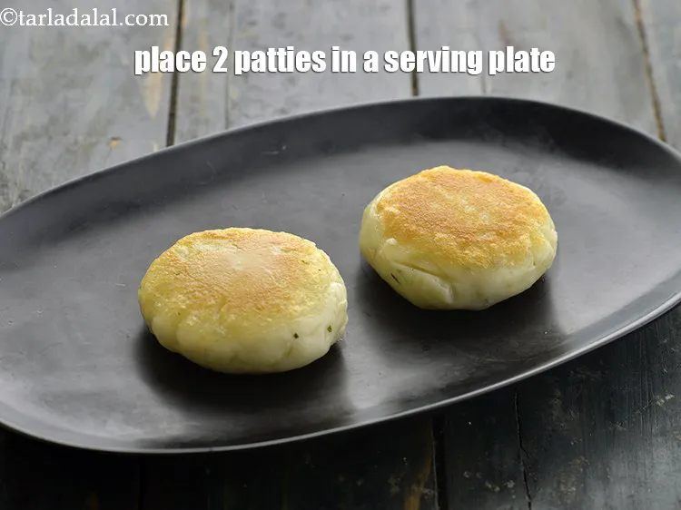 Step 46 – <p>For serving the <strong>ragda patties</strong>, place 2 patties in a shallow serving plate.</p>