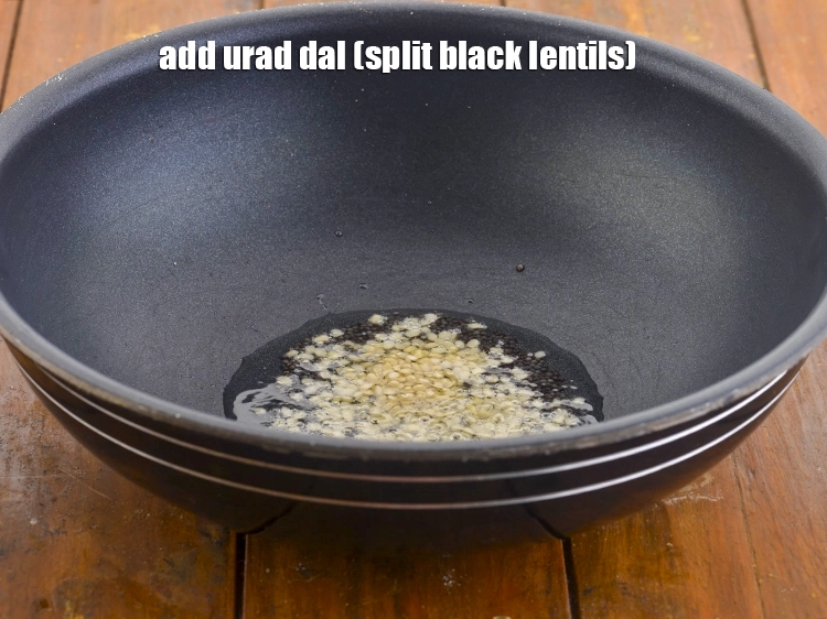 Step 7 – <p>When the seeds begin to splutter, add the <span style="background-color:rgb(255,255,255);color:rgb(0,0,0);">1 tsp </span><a href="https://www.tarladalal.com/glossary-urad-dal-split-black-lentil-941i"><u>urad dal (split …