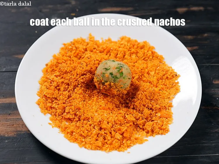 Step 40 – <p><span style="color:rgb(0,0,0);">Coat each ball in the crushed nachos from all the sides.</span></p>