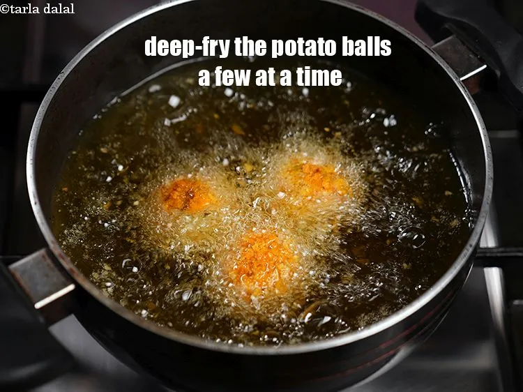 Step 41 – <p>Heat the oil in a kadhai and deep-fry the potato balls a few at a …