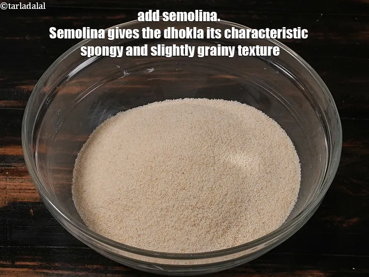 Step 12 – <p>Add 1 cup <a href="https://www.tarladalal.com/glossary-semolina-sooji-rava-rawa-603i">semolina (rava / sooji)</a> Semolina gives the dhokla its characteristic spongy …