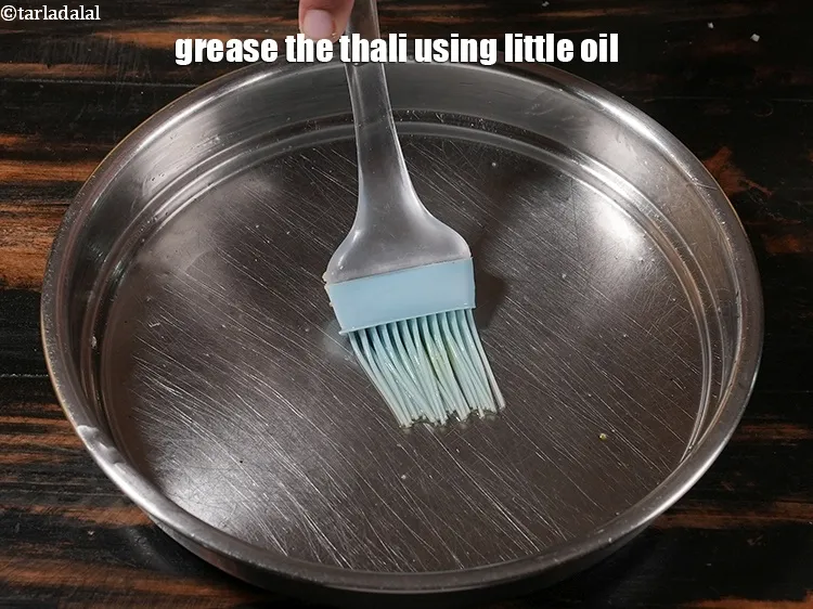 Step 19 – <p>Grease the thali using little oil.</p>