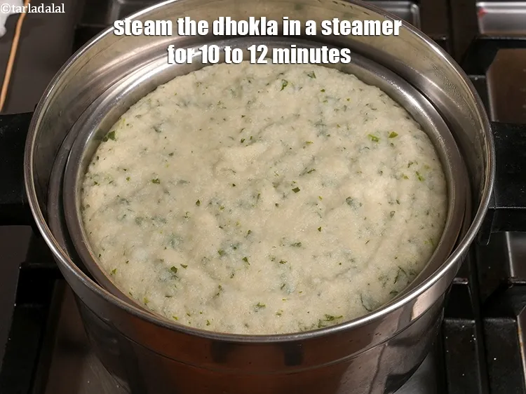 Step 21 – <p>Steam the dhokla in a steamer for 10 to 12 minutes.</p>