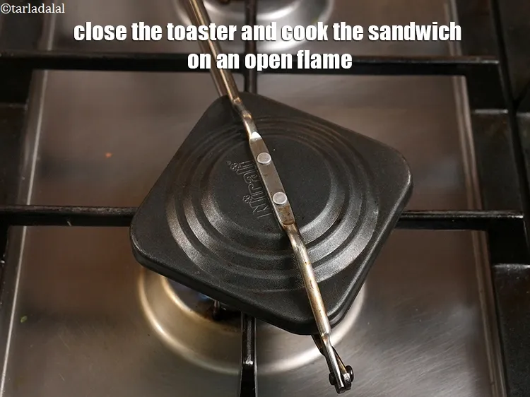 Step 23 – <p>Close the toaster and cook the sandwich on an open flame.</p>