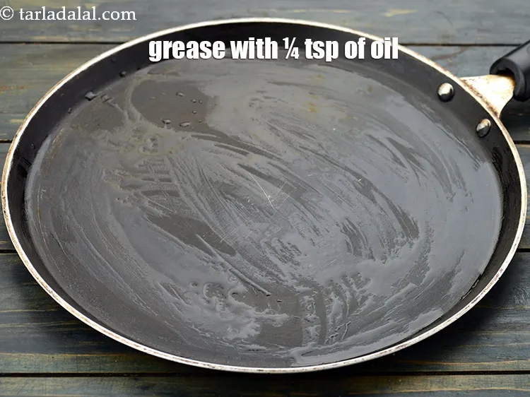 Step 24 – <p>Grease it using ¼ tsp of <a href="https://www.tarladalal.com/glossary-oil-671i">oil</a>.</p>