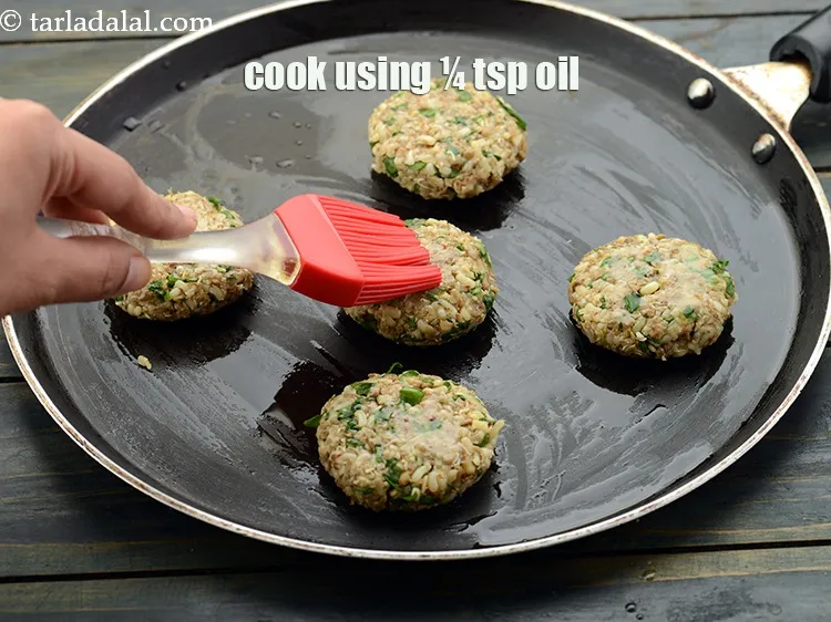 Step 26 – <p>Cook each tikki, using ¼ tsp of <a href="https://www.tarladalal.com/glossary-oil-671i">oil</a>.</p>