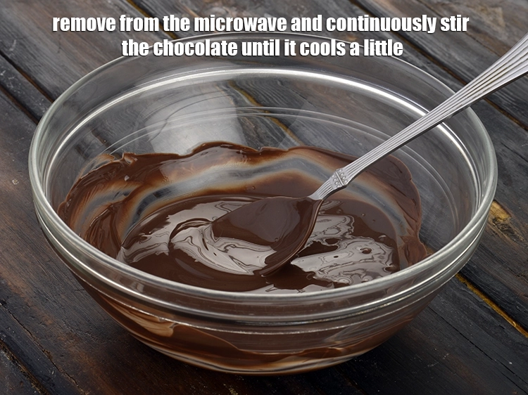 Step 3 – <p style="margin-left:0px;">Remove from the microwave and continuously stir the chocolate until it cools a little.</p>