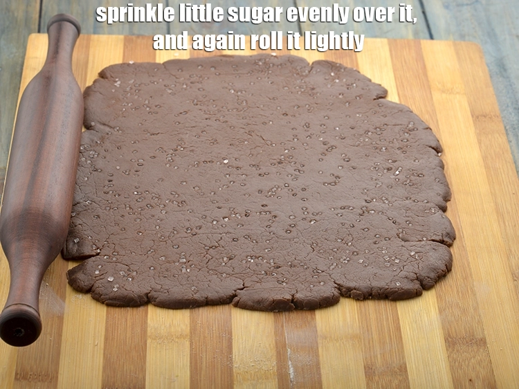 Step 4 – <p><span style="background-color:rgb(255,255,255);color:rgb(0,0,0);">Sprinkle little </span><a href="https://www.tarladalal.com/glossary-sugar-chini-shakkar-278i"><u>sugar</u></a><span style="background-color:rgb(255,255,255);color:rgb(0,0,0);"> evenly over it, and again roll it lightly.</span></p>