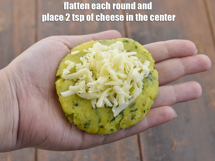 Step 8 – <p><span style="background-color:rgb(255,255,255);color:rgb(0,0,0);">Flatten each round and place 2 tsp of </span><a href="https://www.tarladalal.com/glossary-processed-cheese-315i#ing_3090"><u>grated processed cheese</u></a><span style="background-color:rgb(255,255,255);color:rgb(0,0,0);"> in …