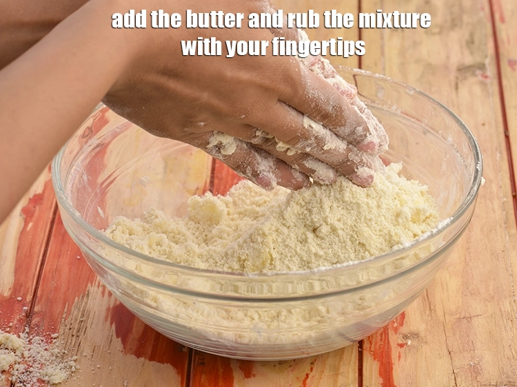 Step 1 – <p><span style="background-color:rgb(255,255,255);color:rgb(0,0,0);">Add the </span><a href="https://www.tarladalal.com/glossary-butter-makhan-233i"><u>butter</u></a><span style="background-color:rgb(255,255,255);color:rgb(0,0,0);"> and rub the mixture with your fingertips.</span></p>