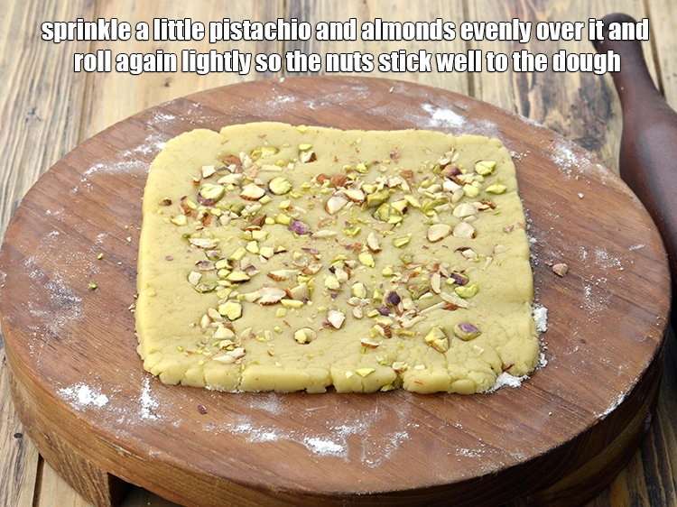 Step 7 – <p><span style="background-color:rgb(255,255,255);color:rgb(0,0,0);">Sprinkle a little finely </span><a href="https://www.tarladalal.com/glossary-pistachios-pista-891i#ing_3236"><u>chopped pistachios</u></a><span style="background-color:rgb(255,255,255);color:rgb(0,0,0);"> and finely </span><a href="https://www.tarladalal.com/glossary-almonds-badam-378i#ing_3231"><u>chopped almonds (badam)</u></a><span …