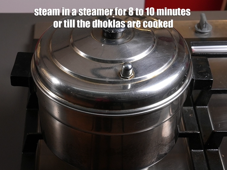 Step 8 – <p><span style="background-color:rgb(255,255,255);color:rgb(0,0,0);">Steam in a steamer for 8 to 10 minutes or till the dhoklas are …