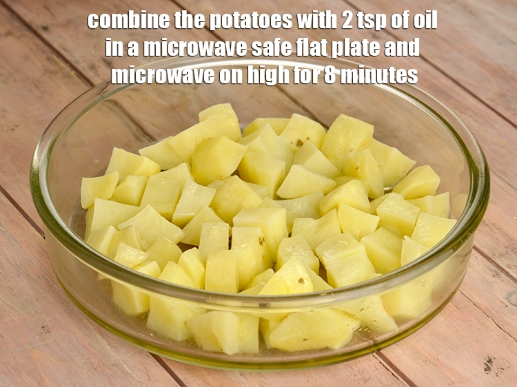 Step 3 – <p><span style="background-color:rgb(255,255,255);color:rgb(0,0,0);">Combine the 2 cups </span><a href="https://www.tarladalal.com/glossary-potatoes-aloo-alu-batata-710i#ing_2328"><u>potato cubes</u></a><span style="background-color:rgb(255,255,255);color:rgb(0,0,0);"> with 2 tsp of </span><a href="https://www.tarladalal.com/glossary-oil-671i"><u>oil</u></a><span …