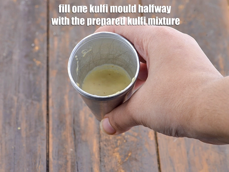 Step 12 – <p><span style="background-color:rgb(255,255,255);color:rgb(0,0,0);">Fill one kulfi mould halfway with the prepared kulfi mixture.</span></p>