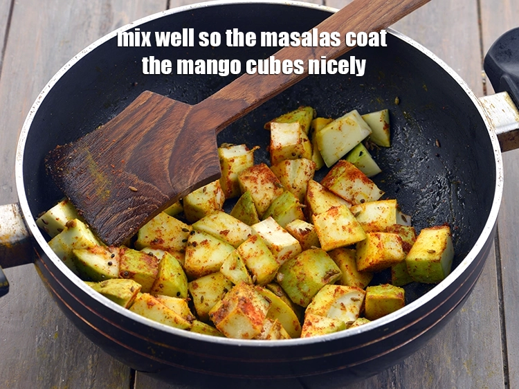 Step 14 – <p>Mix well so the <i>masalas</i> coat the mango cubes nicely.</p>