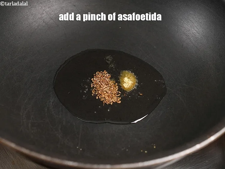 Step 19 – <p><span style="color:rgb(0,0,0);">Add a pinch of </span><a href="https://www.tarladalal.com/glossary-asafoetida-hing-113i">asafoetida (hing)</a>.</p>
