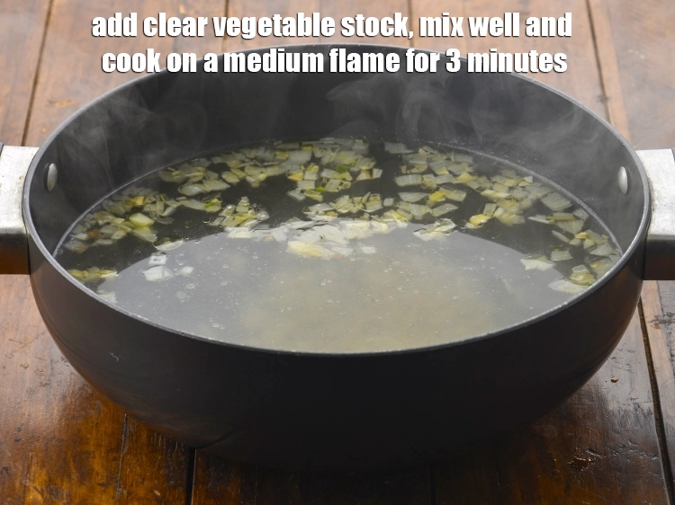 Step 13 – <p><span style="background-color:rgb(255,255,255);color:rgb(0,0,0);">Add the 5 cups </span><a href="https://www.tarladalal.com/clear-vegetable-stock-4181r"><u>clear vegetable stock</u></a><span style="background-color:rgb(255,255,255);color:rgb(0,0,0);">, mix well and cook on …
