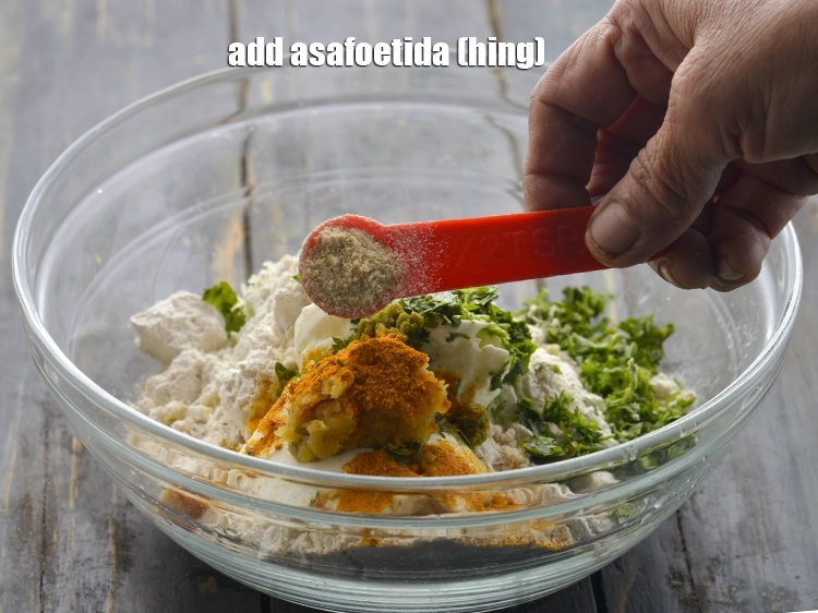 Step 11 – <p>Add ¼ tsp of <a href="https://www.tarladalal.com/glossary-asafoetida-hing-113i"><u>asafoetida (hing)</u></a>. Though muthias are a light snack but, the …