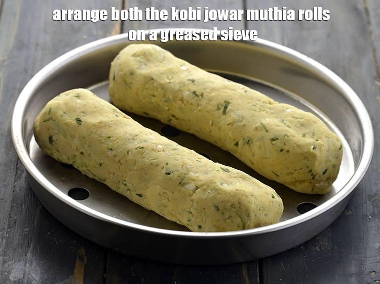 Step 18 – <p>Arrange both the <strong>kobi jowar muthia</strong> rolls on a greased sieve. Keep proper distance between …