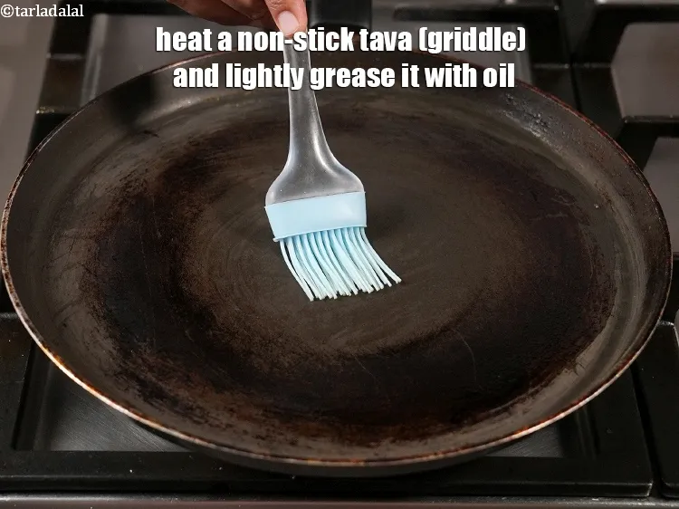 Step 14 – <p>Heat a non-stick tava (griddle) and lightly grease it with ¼ tsp oil.</p>