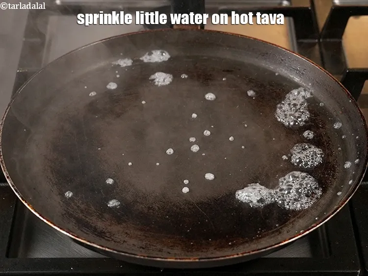 Step 15 – <p>Sprinkle little water on hot tava.</p>
