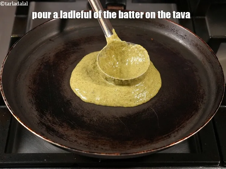 Step 17 – <p>Pour a ladleful of the batter on the tava (griddle).</p>