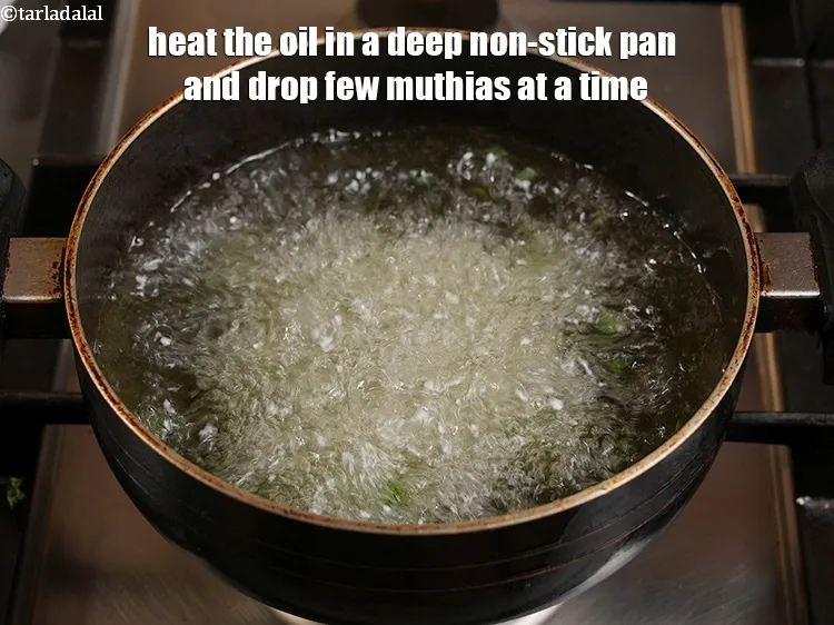 Step 20 – <p>Heat the oil in a deep non-stick pan and drop few muthias at a time.</p>