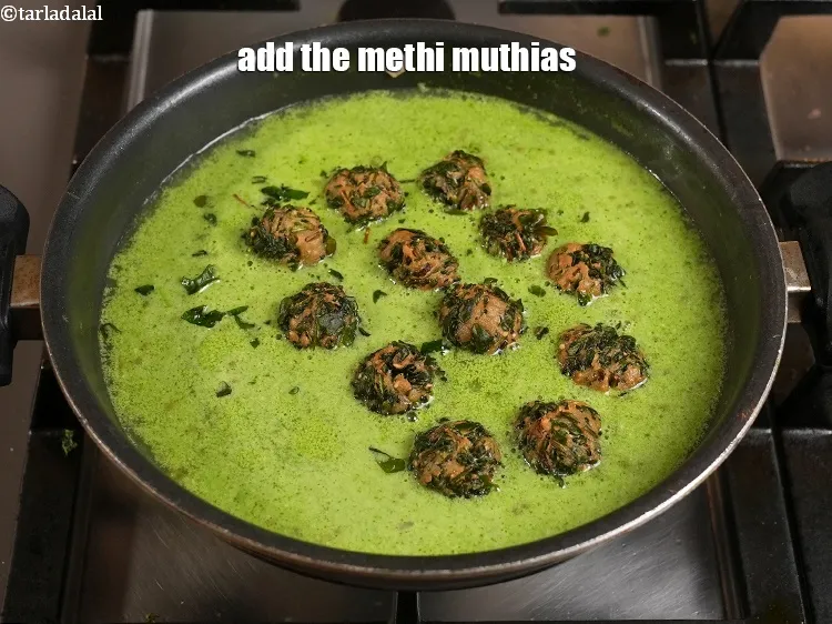 Step 34 – <p>Switch off the flame, add the methi muthias and mix gently.</p>