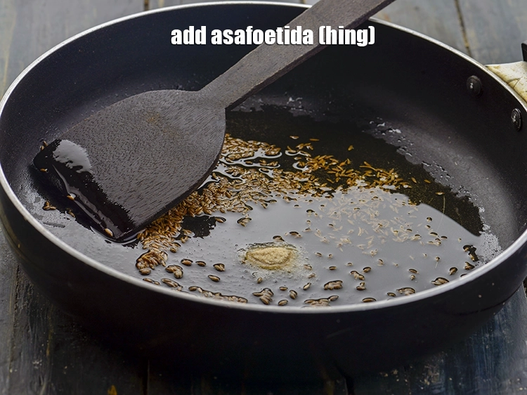 Step 3 – <p>Add the <span style="background-color:rgb(255,255,255);color:rgb(0,0,0);">1/4 tsp </span><a href="https://www.tarladalal.com/glossary-asafoetida-hing-113i"><u>asafoetida (hing)</u></a><span style="background-color:rgb(255,255,255);color:rgb(0,0,0);">.</span></p>
