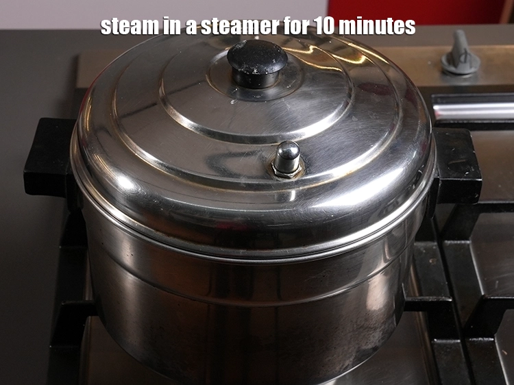 Step 15 – <p>Arrange both the rolls on a greased sieve and steam in a steamer for 10 …