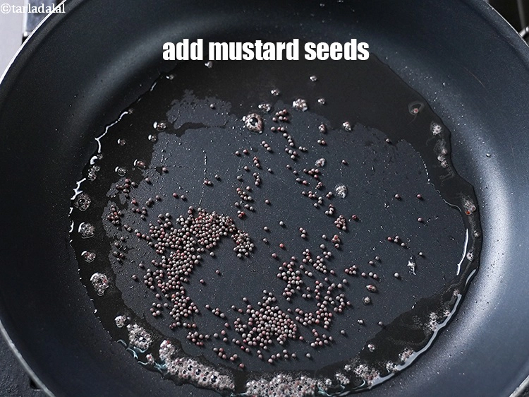 Step 18 – <p>Add the <span style="background-color:rgb(255,255,255);color:rgb(0,0,0);">1/2 tsp </span><a href="https://www.tarladalal.com/glossary-mustard-seeds-sarson-rai-sarson-ke-beej-525i"><u>mustard seeds ( rai / sarson)</u></a> to it.&nbsp;</p>