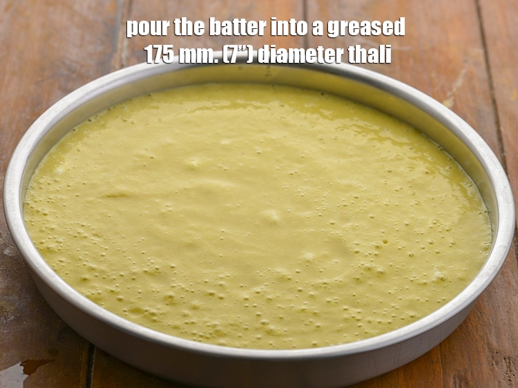 Step 34 – <p><span style="background-color:rgb(255,255,255);color:rgb(0,0,0);">Pour the batter into a greased 175 mm. (7”) diameter thali.</span></p>