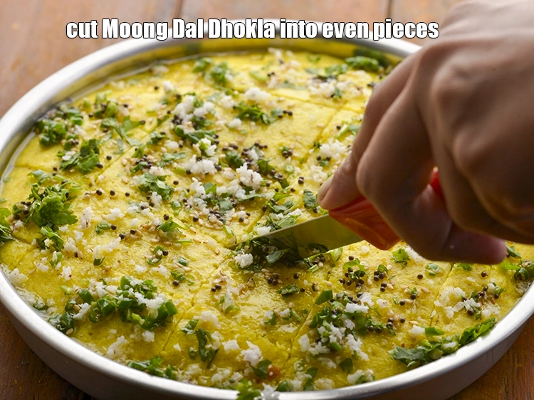 Step 27 – <p><span style="background-color:rgb(255,255,255);color:rgb(0,0,0);">Cut&nbsp;<strong>Moong Dal Dhokla</strong>&nbsp;into even pieces.</span></p>