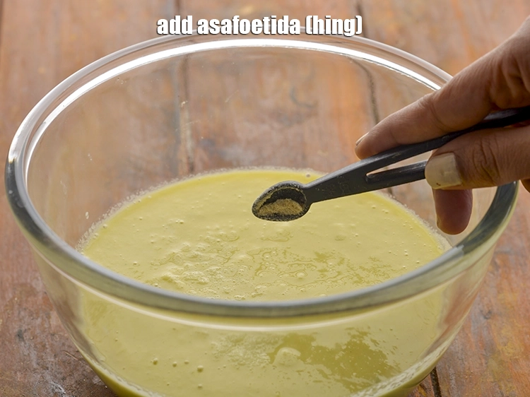Step 30 – <p>Add the asafoetida to the batter. Dals and pulses are a bit difficult to digest, …