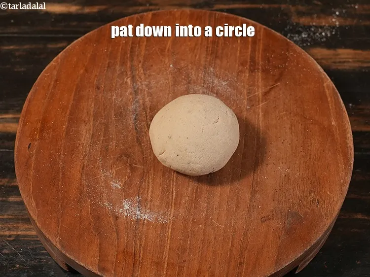 Step 21 – <p>Pat down into a circle. Rajgira is difficult to roll and you need some practise.&nbsp;</p>