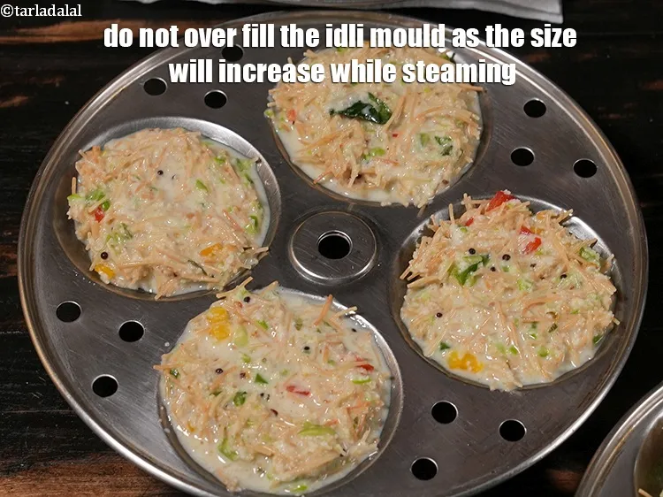 Step 57 – <p><span style="color:rgb(0,0,0);">Do not over fill the idli mould as the size will increase while steaming.</span></p>