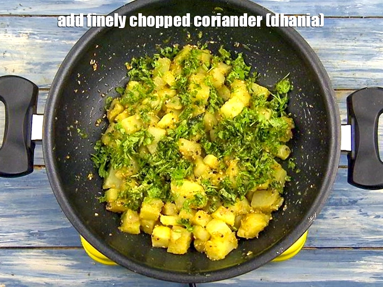 Step 18 – <p>Add <span style="background-color:rgb(255,255,255);color:rgb(0,0,0);">1/4 cup finely </span><a href="https://www.tarladalal.com/glossary-coriander-dhania-kothmir-369i#ing_2365"><u>chopped coriander (dhania)</u></a> to perk up the&nbsp;<strong>Bateta Nu Shaak</strong>.</p>