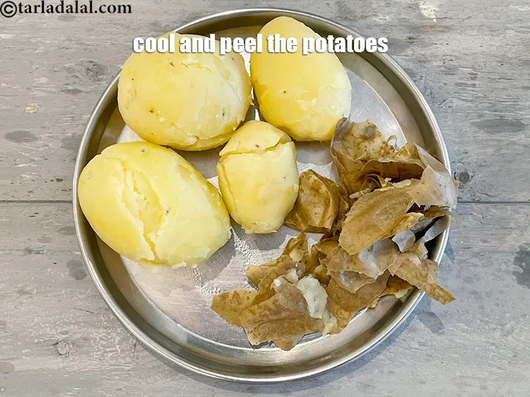 Step 5 – <p>Once the potatoes are cooked. Let them come down to room temperature and peel them.</p>