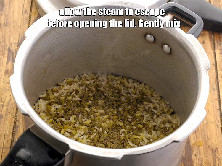 Step 16 – <p>Allow the steam to escape before opening the lid. Gently mix the <strong>moong dal khichdi</strong> …