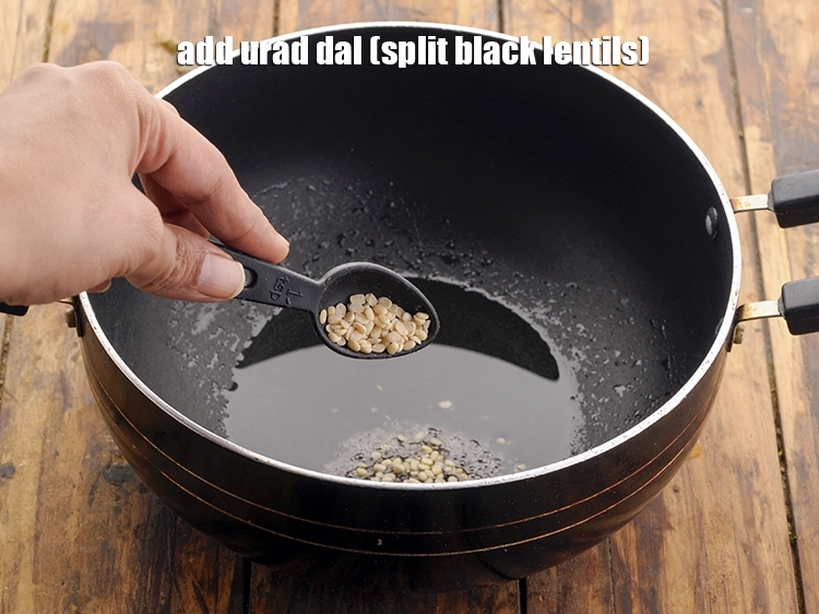 Step 19 – <p><span style="background-color:rgb(255,255,255);color:rgb(0,0,0);">Add 1 tsp </span><a href="https://www.tarladalal.com/glossary-urad-dal-split-black-lentil-941i"><u>urad dal (split black lentils)</u></a><u>.</u></p>