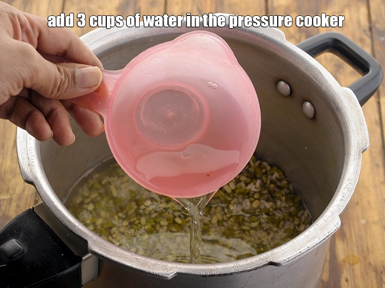 Step 14 – <p>Add 3 cups of water in the pressure cooker.</p>
