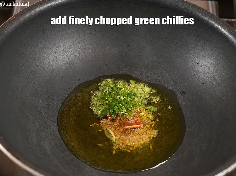 Step 12 – <p>Add 1 tsp finely <a href="https://www.tarladalal.com/glossary-chopped-green-chilli-820i">chopped green chillies</a>.</p>