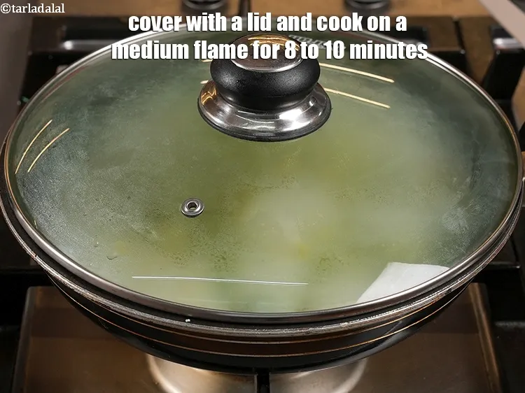 Step 23 – <p>Cover with a lid and cook on a medium flame for 8 to 10 minutes, …