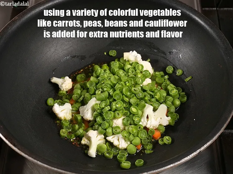 Step 28 – <p>Using a variety of colorful vegetables like carrots, peas, beans and cauliflower is added for …