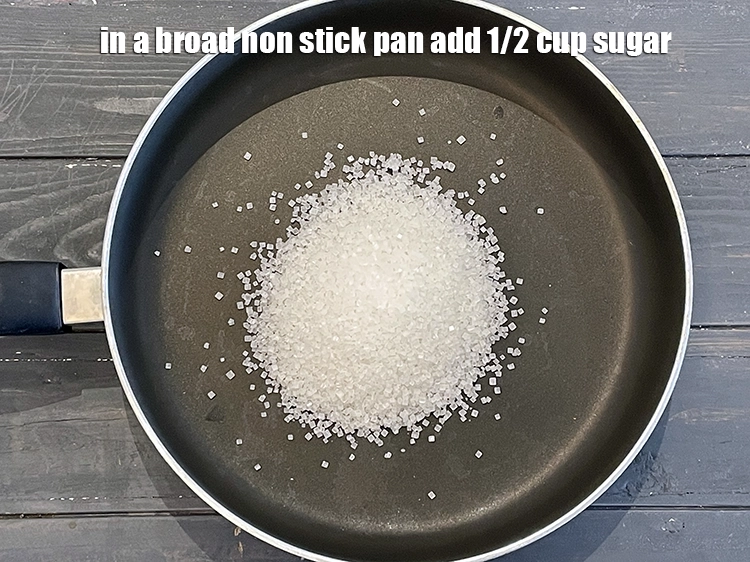 Step 4 – <p><span style="background-color:rgb(255,255,255);color:rgb(0,0,0);">In a broad non stick pan add 1/2 cup </span><a href="https://www.tarladalal.com/glossary-sugar-chini-shakkar-278i"><u>sugar</u></a><u>.</u></p>