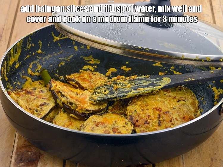 Step 14 – <p>Add <a href="https://www.tarladalal.com/glossary-brinjal-baingan-eggplant-aubergine-128i#ing_2659"><u>brinjal (baingan / eggplant) slices</u></a> and 1 tbsp of <strong>water</strong>, mix well and …
