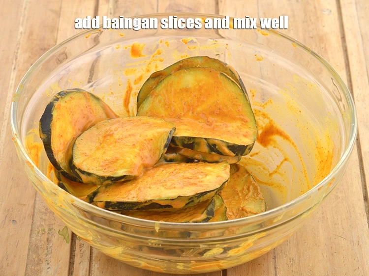 Step 6 – <p><span style="background-color:rgb(255,255,255);color:rgb(0,0,0);">Add the </span><a href="https://www.tarladalal.com/glossary-brinjal-baingan-eggplant-aubergine-128i#ing_2659"><u>brinjal (baingan / eggplant) slices</u></a><span style="background-color:rgb(255,255,255);color:rgb(0,0,0);"> and mix well. Keep aside.</span></p>