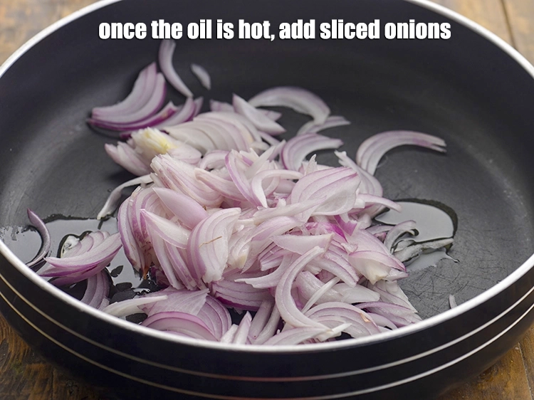 Step 14 – <p>Once the oil is hot, add the <span style="background-color:rgb(255,255,255);color:rgb(0,0,0);">1 cup </span><a href="https://www.tarladalal.com/glossary-onions-pyaz-pyaaz-kanda-548i#ing_2342"><u>sliced onions</u></a>.</p>
