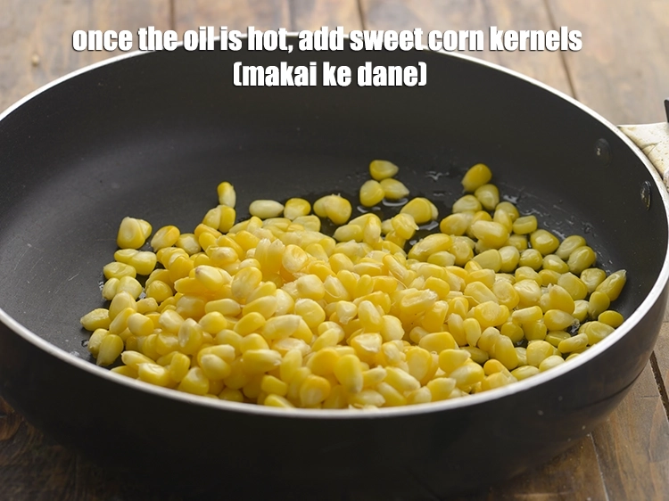 Step 10 – <p>Once the oil is hot, add the <span style="background-color:rgb(255,255,255);color:rgb(0,0,0);">1 cup </span><a href="https://www.tarladalal.com/glossary-sweet-corn-kernels-makai-ke-dane-156i#ing_2309"><u>boiled sweet corn kernels …