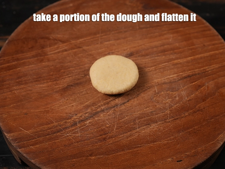 Step 8 – <p><span style="background-color:rgb(255,255,255);color:rgb(0,0,0);">Take a portion of the dough and flatten it.</span></p>